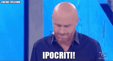 a bald man with a beard says ipocriti on a television screen