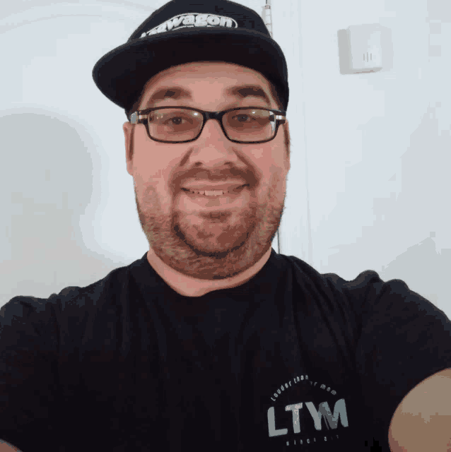 a man wearing glasses and a hat that says wagon on it