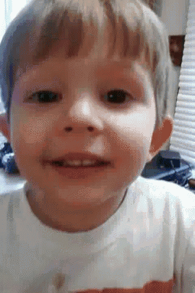 a close up of a child 's face with a white shirt