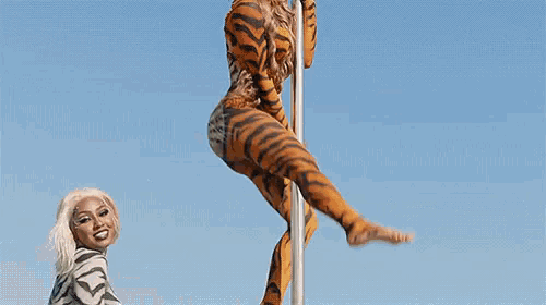 a woman in a zebra print bodysuit is standing in the water