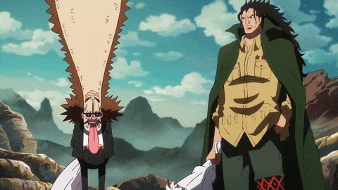 a man in a green cape stands next to another man with a long tongue sticking out