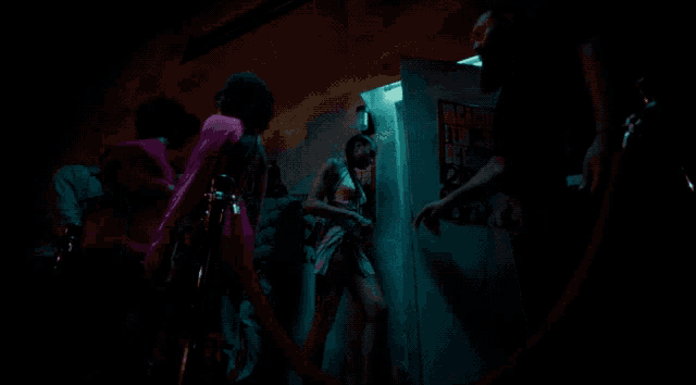 a woman in a pink dress is being escorted into a doorway