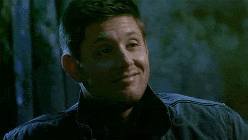 a man is smiling with his eyes closed and his mouth open .