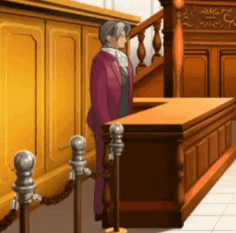 a man in a purple suit is standing in front of a judge 's bench
