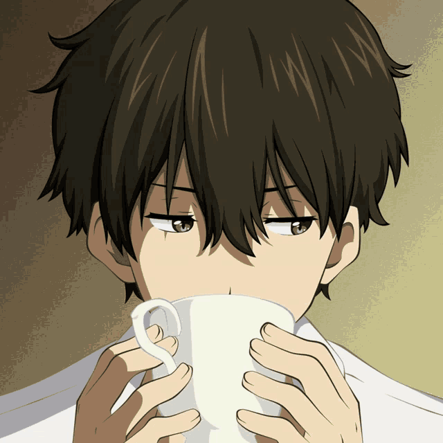 a boy with dark hair is drinking from a white mug