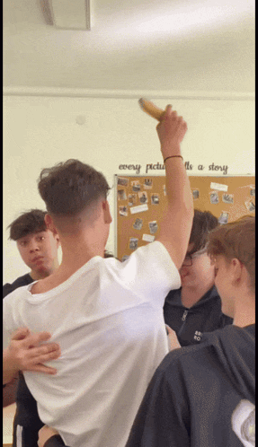a group of young men are gathered in front of a wall that says every picture is a story