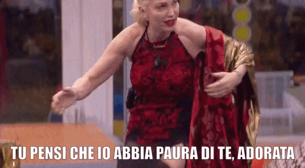 a woman in a red dress with the words tu pensi che io abbia paura di te adorata