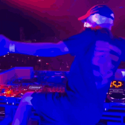 a dj playing music in front of a crowd with a shirt that says champion on the back