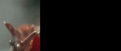 a blurry picture of a person holding a sword in their hand .
