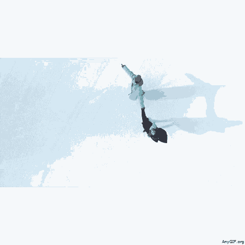 an aerial view of two people holding hands in a snowy field