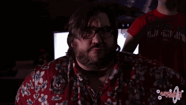 a man wearing glasses and a red shirt with the year 2001