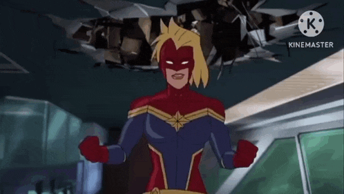 captain marvel is standing in front of a broken glass ceiling .