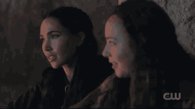 two women are sitting next to each other with a cw logo on the bottom right