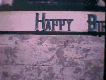a sign that says happy birthday is on a brick wall