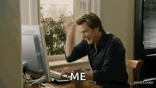a man is sitting at a desk in front of a computer with a cup of coffee .