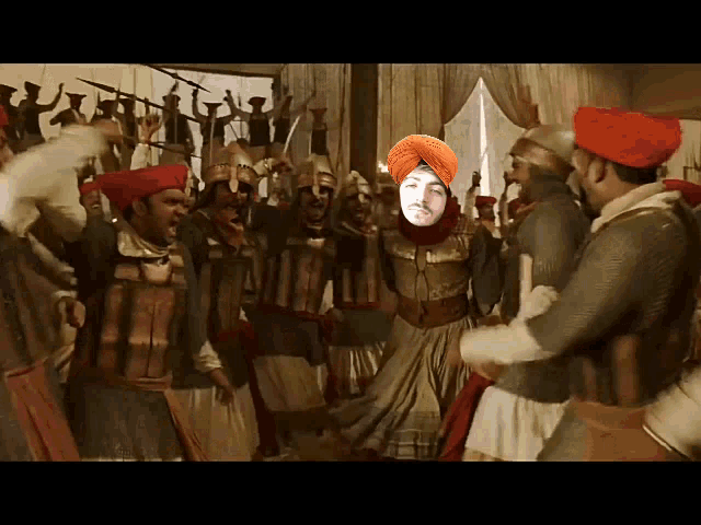 a man in a turban is surrounded by soldiers in red turbans