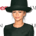 a woman wearing a top hat and a black jacket .
