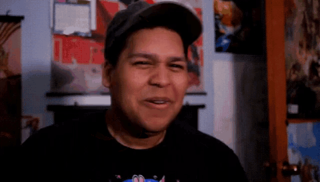 a man wearing a hat and a black shirt with sonic on it