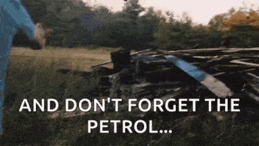 a man in a blue shirt is standing in a field with the words and don 't forget the petrol