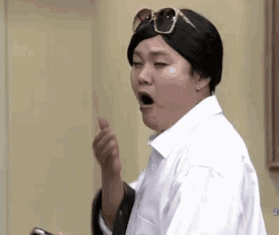 a man wearing a white shirt and sunglasses is making a funny face .