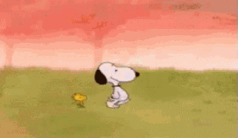 woodstock and snoopy are sitting at a table eating food
