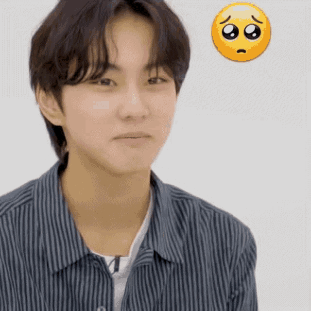 a young man in a striped shirt is making a sad face next to a smiley face .