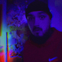 a man with a beard wearing a black hat and a red nike shirt