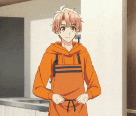 a boy wearing an orange hoodie and an apron is standing in a kitchen