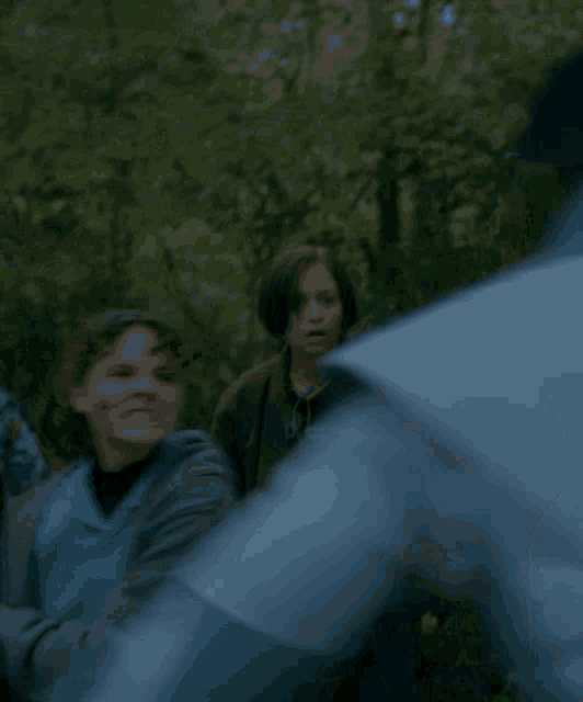 a blurry picture of a group of people including a man in a white shirt