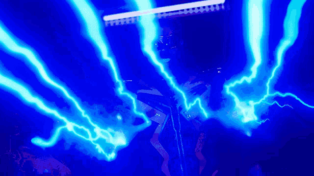 a blue lightning bolt is being projected on a person 's face