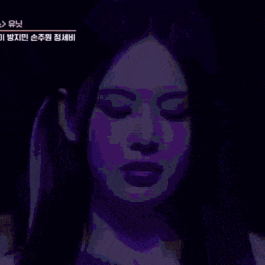 a close up of a woman 's face with korean writing on her face