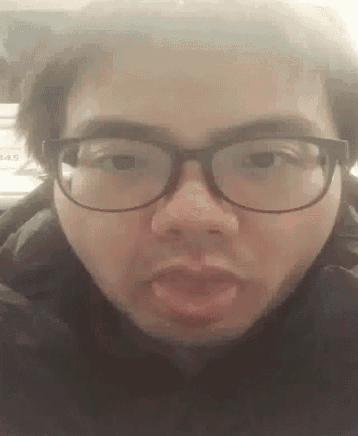a man wearing glasses is making a funny face with his mouth open