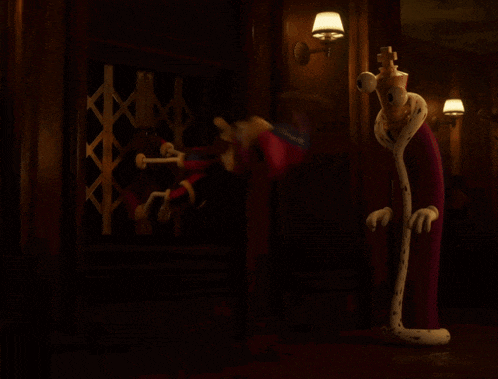 a cartoon character standing in a dark room with a crown on his head