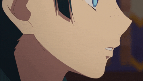 a close up of a person 's face with blue eyes and a few freckles
