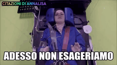 a woman is laying in an ambulance with the words " adesso non esageriamo " written above her