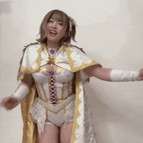 a woman is wearing a white and gold outfit with a purple ribbon