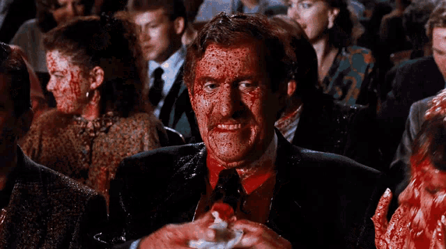 a man with blood on his face holds a napkin
