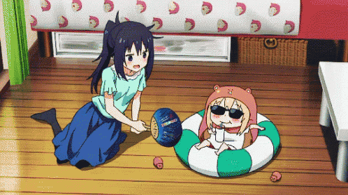 a girl playing with a ball while another girl sits on a life preserver
