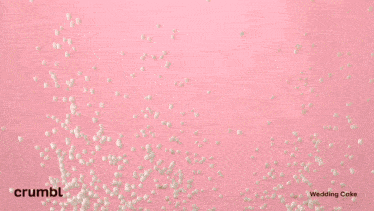 a rose shaped frosting is being piped into a cookie