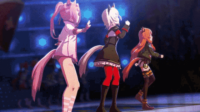 three anime girls are dancing on a stage in front of a crowd