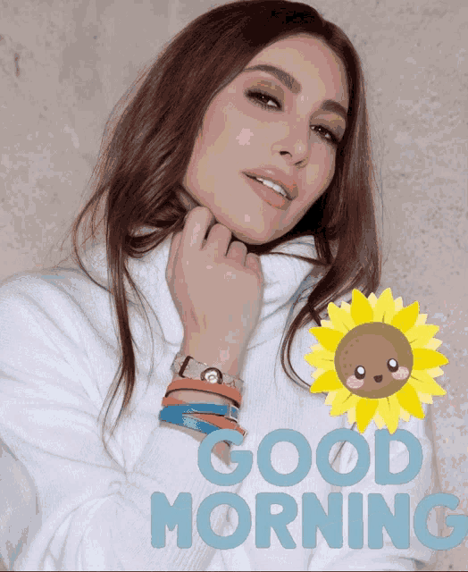 a woman wearing a white sweater with the words good morning written in blue