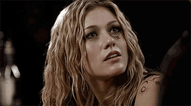 a woman with a tattoo on her arm that says 6 on it