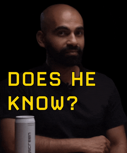 a man sitting at a table with the words " does he know " written above him
