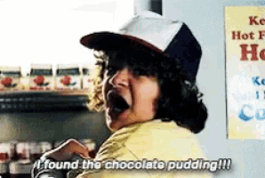 a man wearing a hat and a yellow shirt says " i found the chocolate pudding "