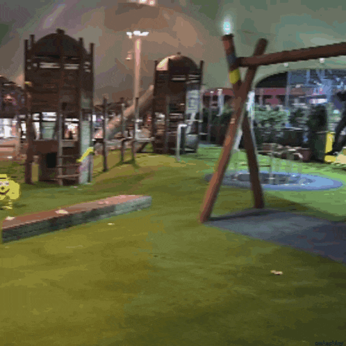 a person swinging on a wooden swing in a park