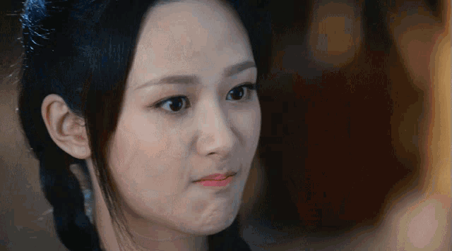 a close up of a woman making a face with her mouth open