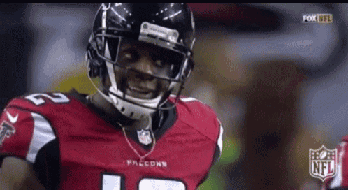 a falcons football player wearing a helmet and number 12 jersey