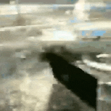 a blurred image of a person 's hand reaching out towards something
