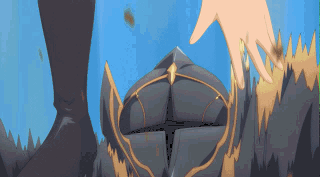 a person 's hand is reaching out to touch a helmet with a cross on it