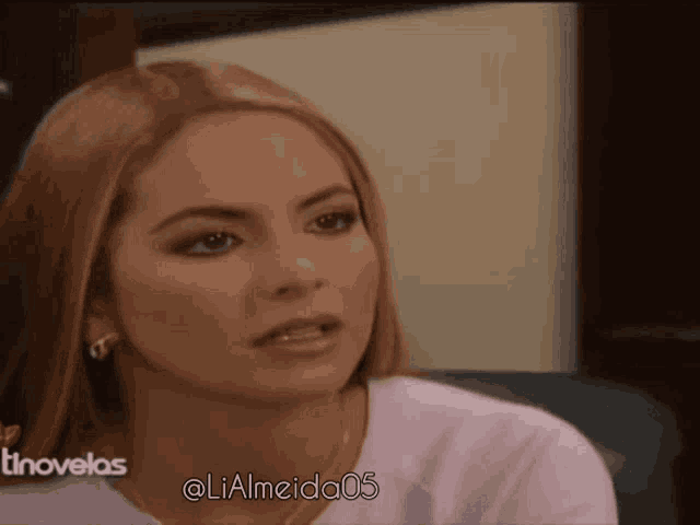 a close up of a woman 's face with the hashtag @ lialmeida05